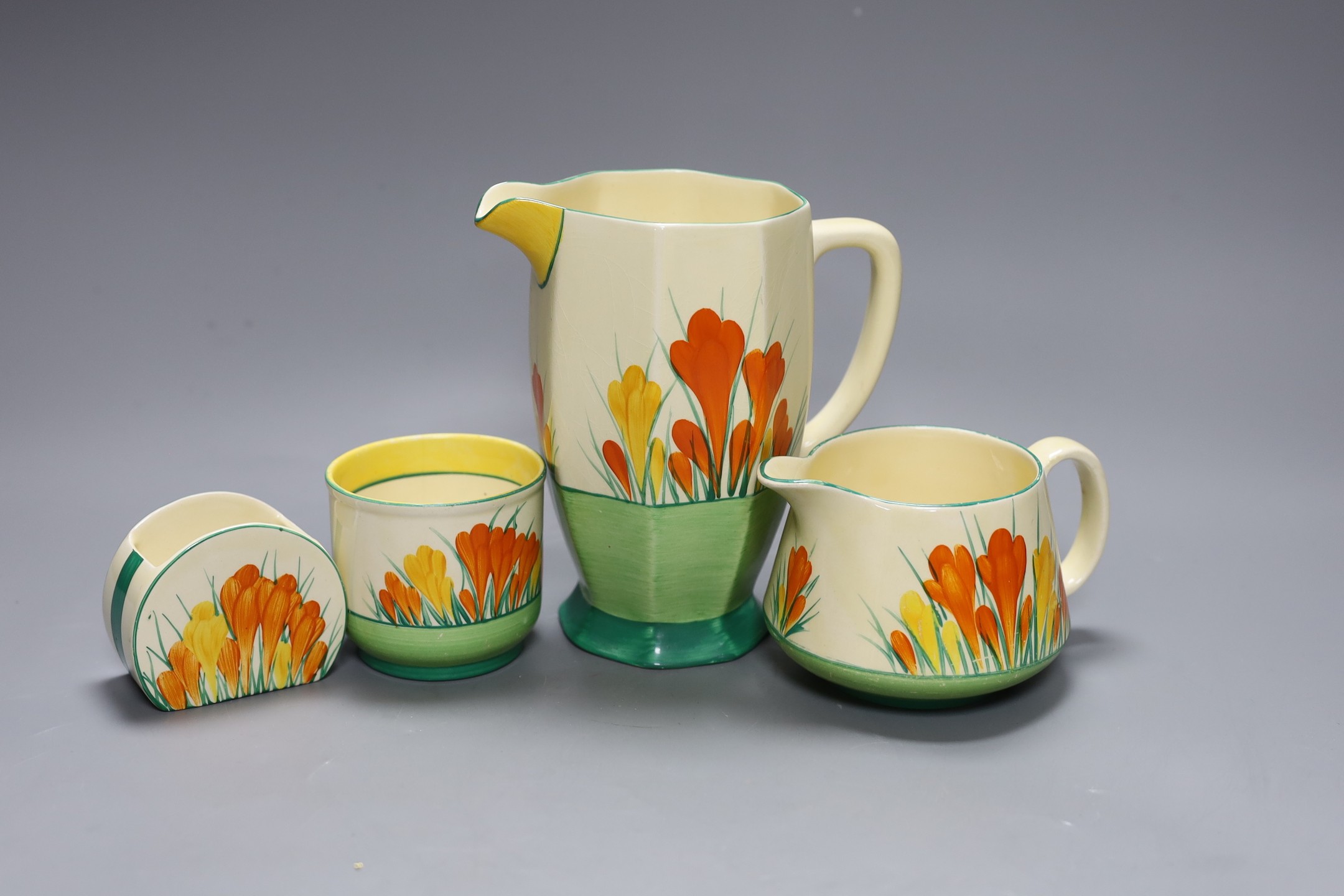 Two Clarice cliff “Sungleam”, crocus jugs and two pots, (4), tallest jug 17 cms high
